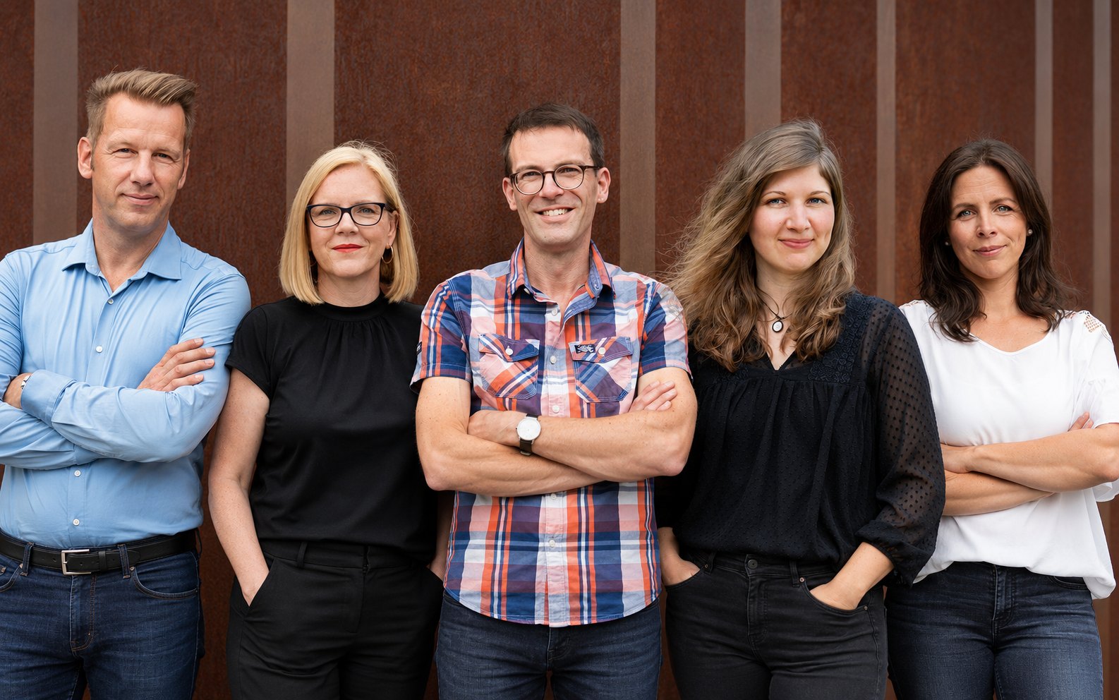 Das Team von KOKON Architektur vor der Cortenstahl-Wand